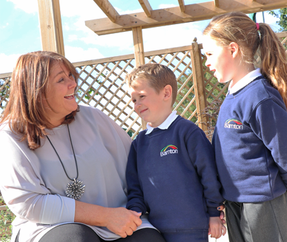 Our headteacher talking with 2 pupils